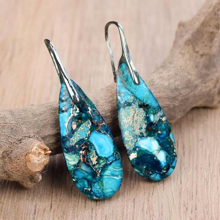 Distinctive women's drop-shaped emperor stone earrings; elegant natural gemstone jewelry.