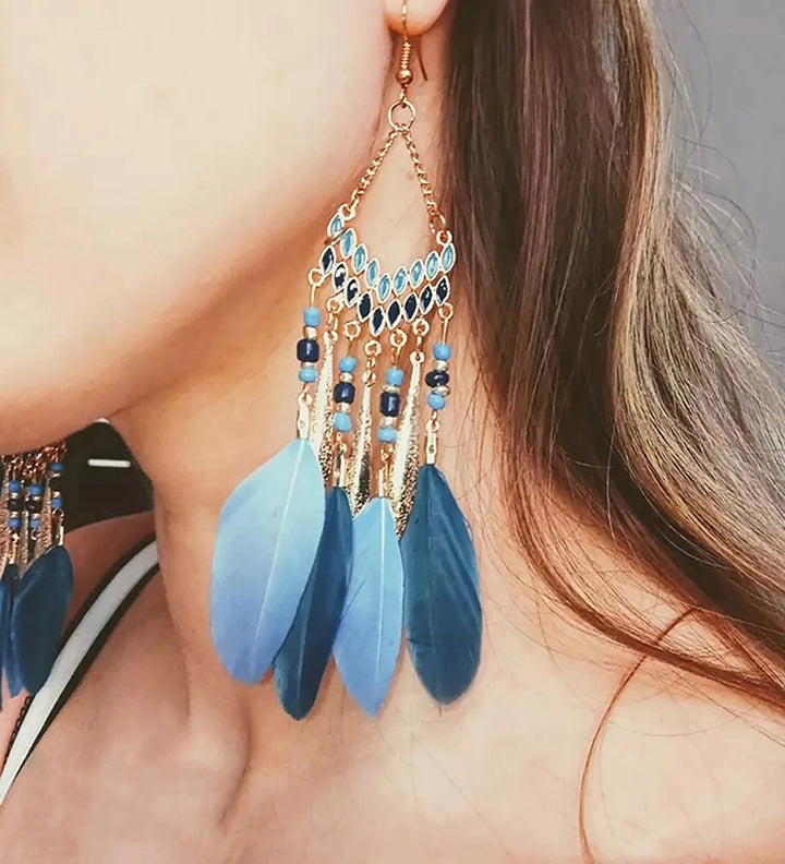 Women's elegant feather dangle earrings, perfect for a chic look. Gold plated and hypoallergenic.