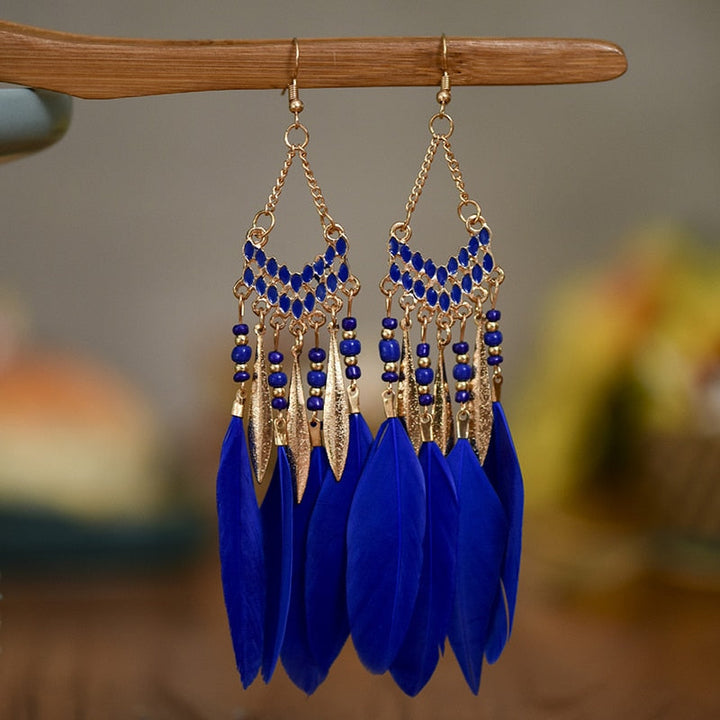 Elegant women's feather dangle earrings. Lightweight statement jewelry, gold plated for a sophisticated touch.