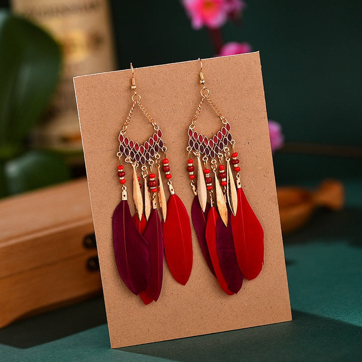 Stunning women's feather dangle earrings, embodying bohemian elegance. Gold plated, perfect statement jewelry.