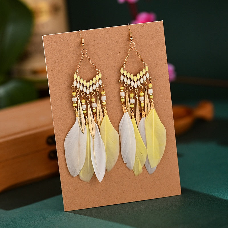 Fashionable women's elegant feather dangle earrings. Gold plated, hypoallergenic long earrings for any occasion.