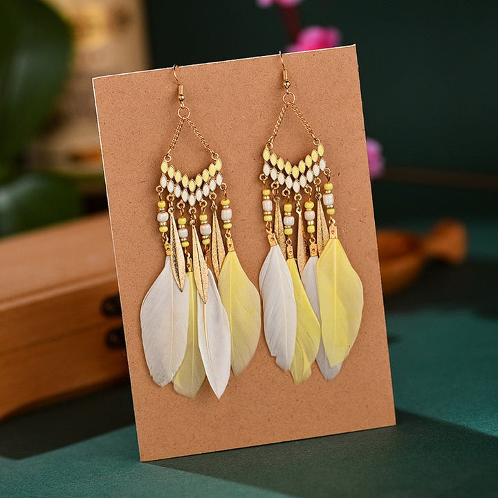 Fashionable women's elegant feather dangle earrings. Gold plated, hypoallergenic long earrings for any occasion.
