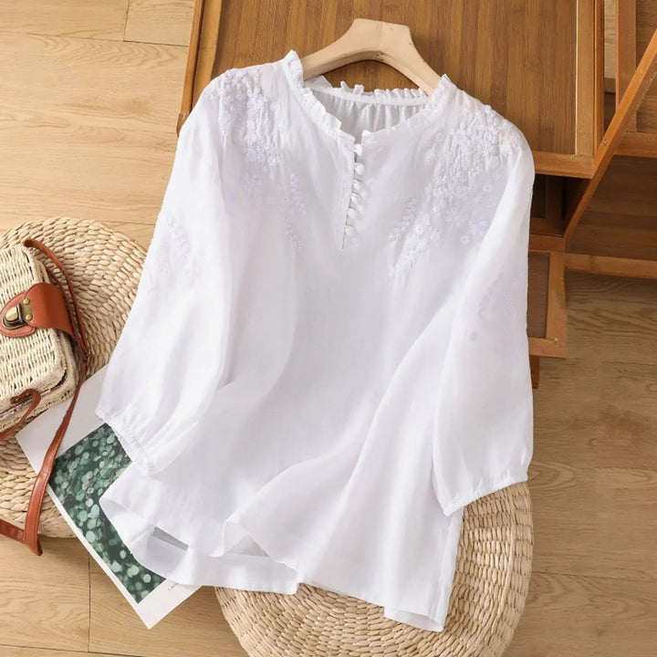 Feminine floral embroidered button-front blouse for women, a stylish long sleeve summer top.