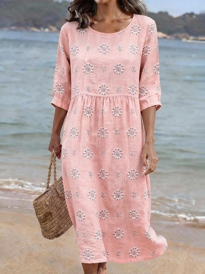 Elegant women's embroidered midi dress with vibrant floral print, comfortable fit, and flowy silhouette for spring/summer.
