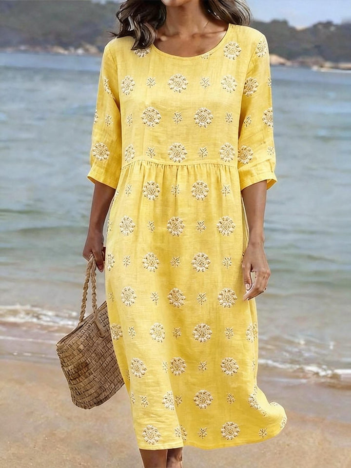 Stylish women's midi dress featuring elegant floral embroidery, three-quarter sleeves, and a comfortable, flowy silhouette.