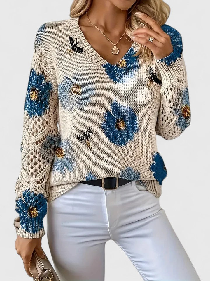 Close-up: Soft knit fabric on women's floral cardigan, intricate pattern detail.