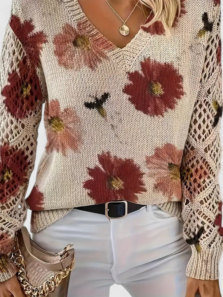 Detail of v-neck and floral knit pattern on a women's stylish long sleeve cardigan.