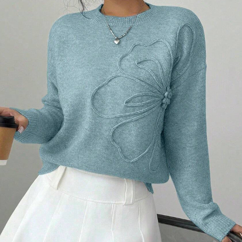 Soft knit women's sweater with elegant floral design, a comfortable long sleeve pullover for casual or dressed-up wear.