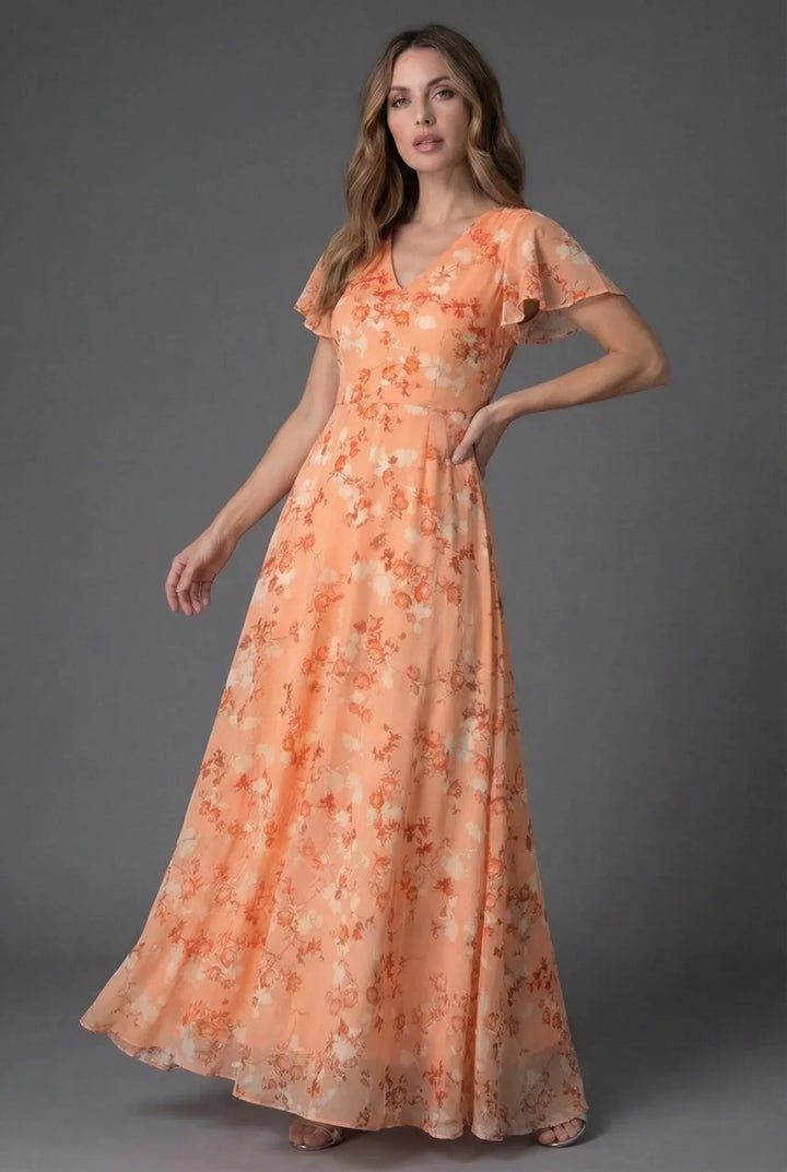 Close-up: Women's floral maxi dress with V-neck and delicate flutter sleeves. Elegant spring/summer fashion.