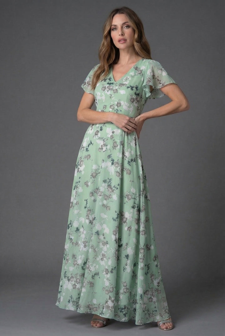 Full length: Elegant women's floral maxi dress with flowing fabric, V-neck, & flutter sleeves for evening wear.