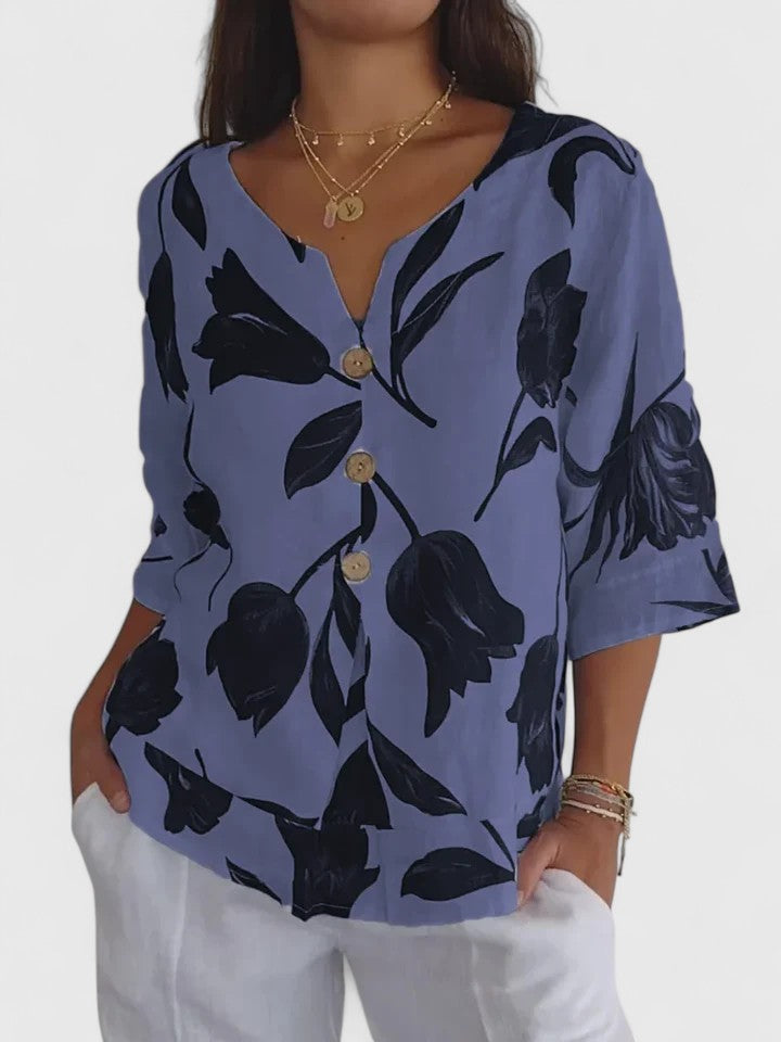 Close-up of a women's floral print V-neck blouse, showcasing elegant fabric & comfortable fit.