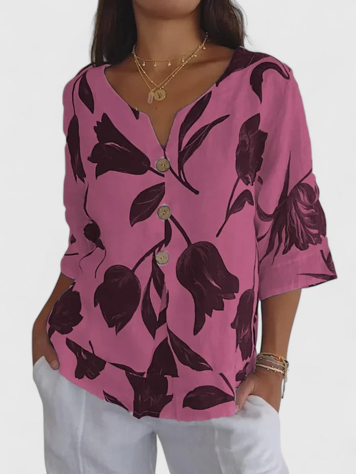 Woman wearing a comfortable & stylish floral V-neck blouse, a versatile long sleeve top for women.