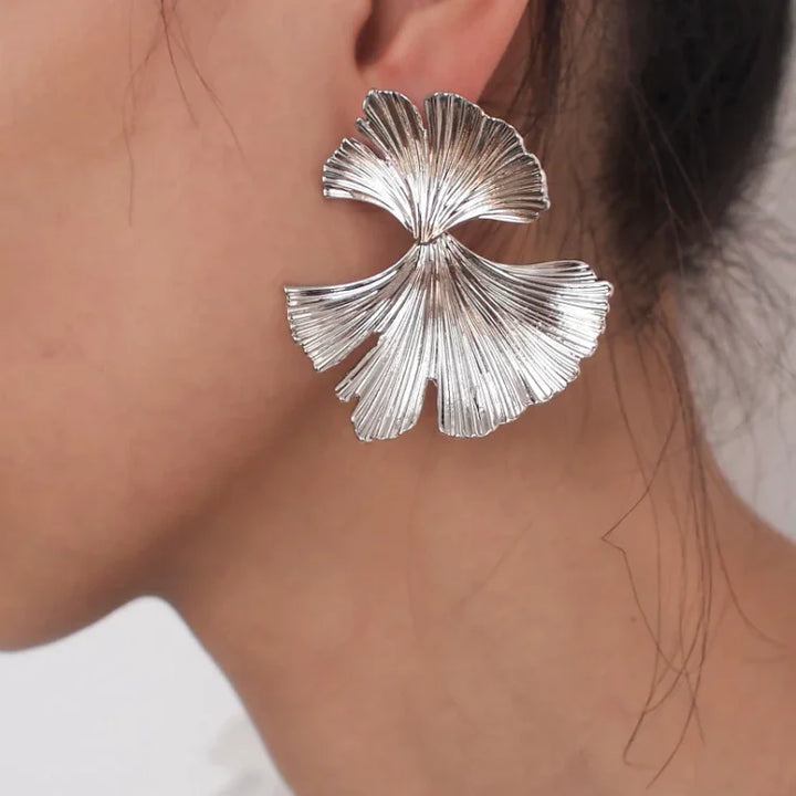 Women's elegant flower dangle earrings in gold and silver, Liora collection. Perfect sophisticated jewelry.