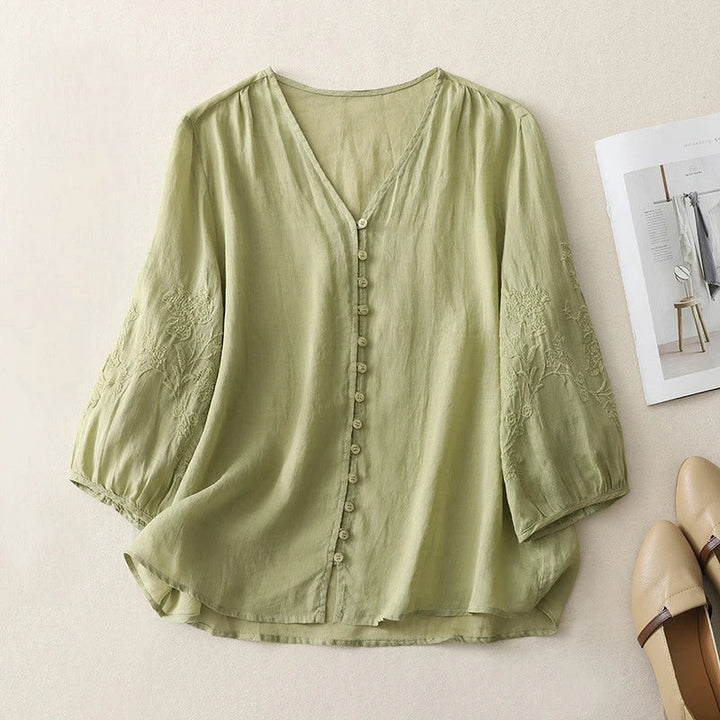 Flowing women's blouse with intricate embroidery, a comfortable and elegant button-down shirt for warm seasons.
