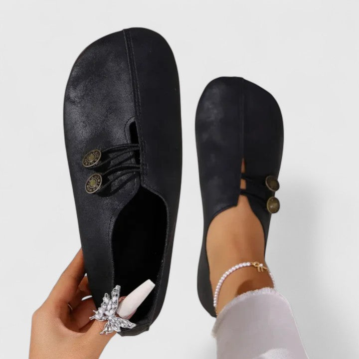 Comfortable women's travel flats with padded insole and elastic button closure, featuring a foldable design.
