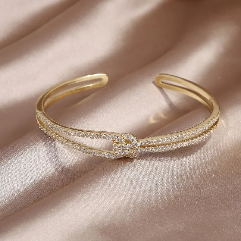 Glistening gold knot crystal women's bracelet, adding sparkle to any outfit.