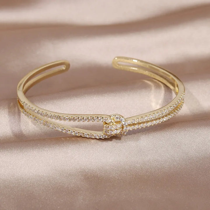 Sophisticated gold knot crystal bangle, a stunning women's fashion statement.