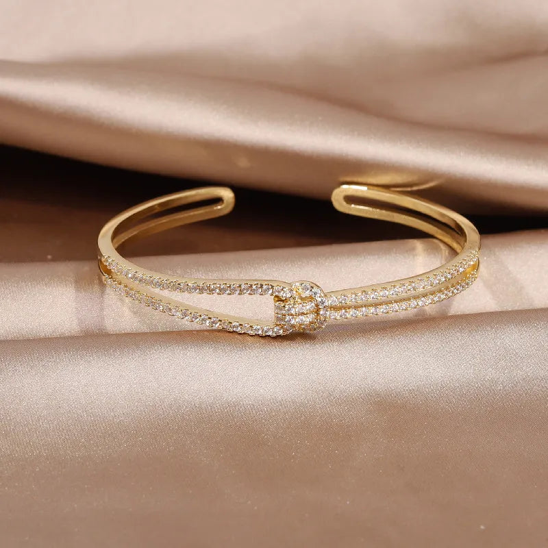 Beautiful gold knot crystal bangle, an elegant and sparkling women's accessory.
