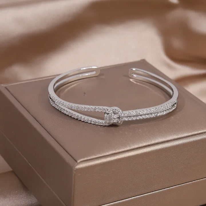 Close-up of a glittering gold knot crystal bangle, luxurious women's jewelry.
