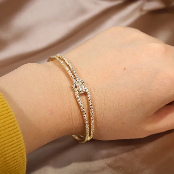 Dazzling gold knot design crystal bracelet for women, an elegant fashion accessory.