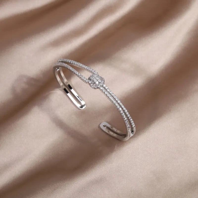 Shiny women's gold knot crystal bangle, a classic and sophisticated jewelry piece.