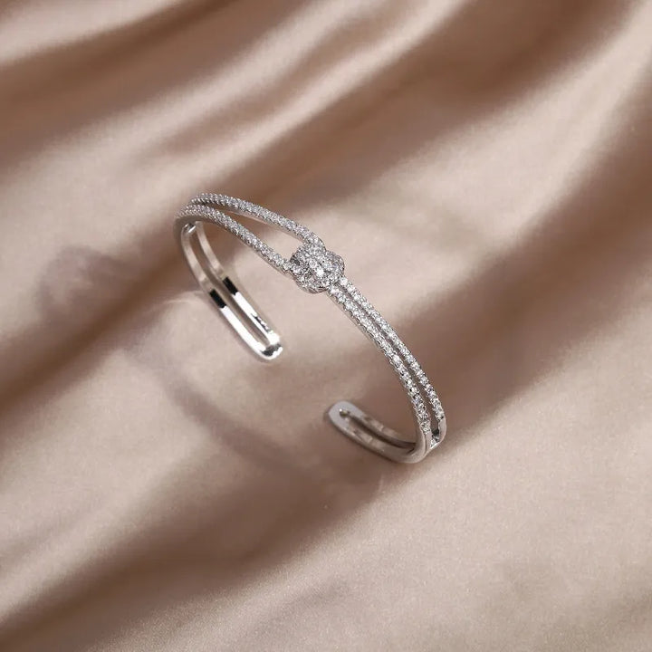 Shiny women's gold knot crystal bangle, a classic and sophisticated jewelry piece.