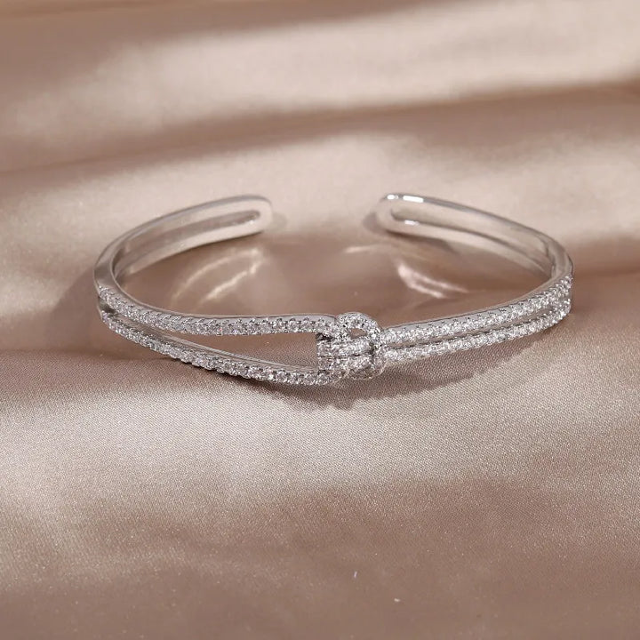Luxurious gold crystal knot bangle bracelet, a timeless women's accessory.