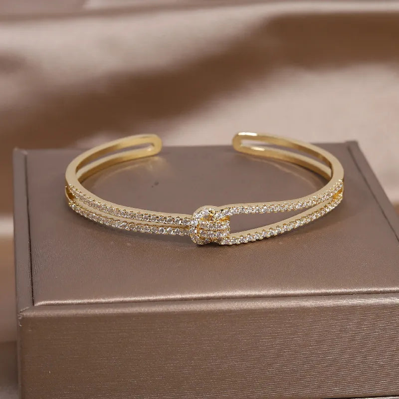 Elegant women's gold knot crystal bangle, ideal for special occasions & gifts.