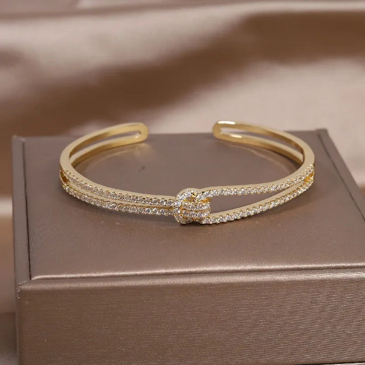 Elegant women's gold knot crystal bangle, ideal for special occasions & gifts.