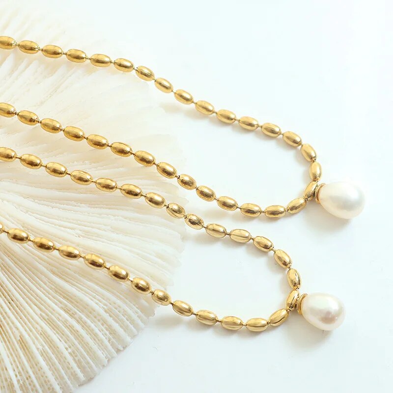 Close-up of an elegant gold pearl beaded necklace for women. Classic, high-fashion jewelry accessory.