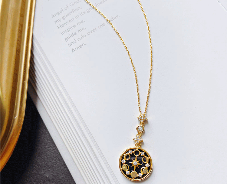 Elegant women's gold plated Divine Totem necklace worn, a spiritual and celestial jewelry accessory.
