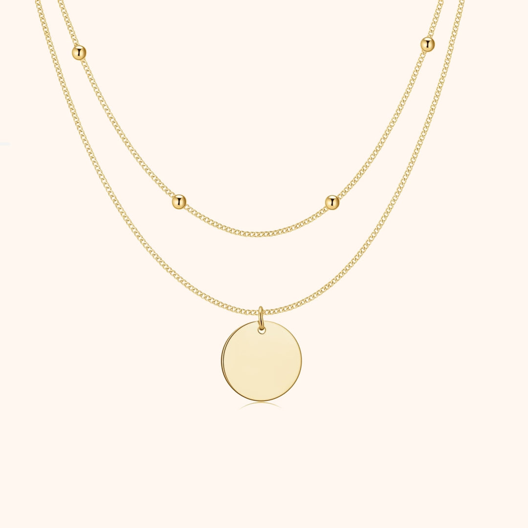 Dainty women's double medallion layered necklace in gold plated silver. Elegant jewelry accessory for a stylish look.