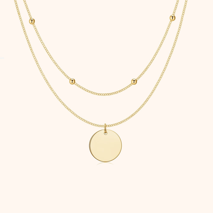 Dainty women's double medallion layered necklace in gold plated silver. Elegant jewelry accessory for a stylish look.