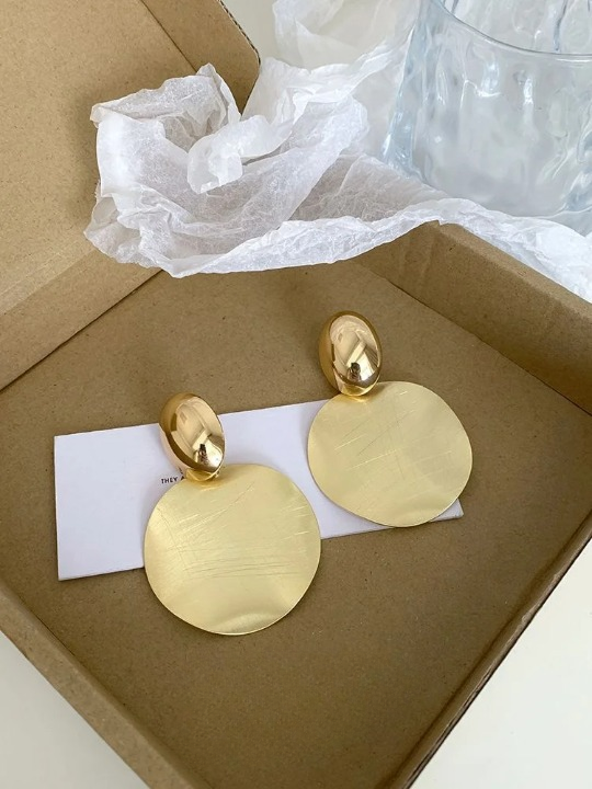 Close-up of women's gold-plated round pendant earrings, showcasing their elegant, polished finish.