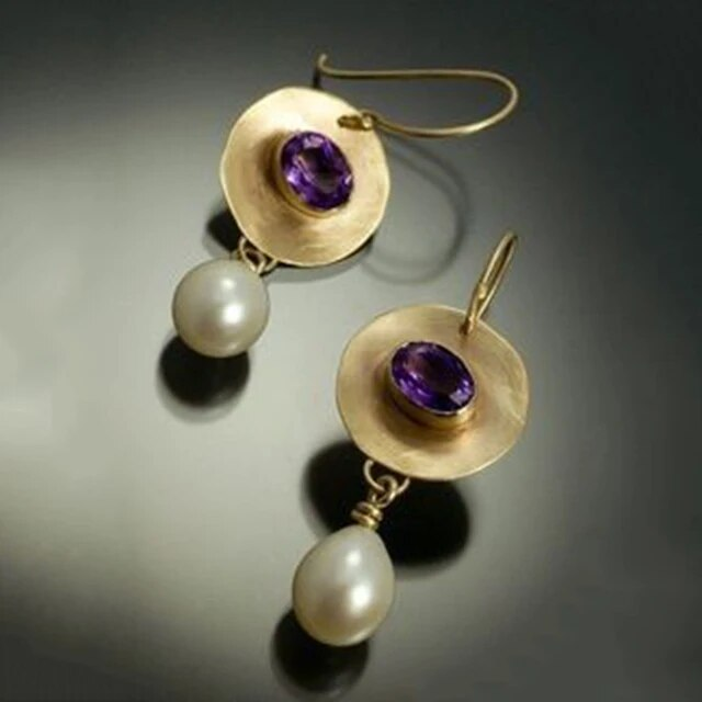 Women's elegant gold-plated vintage earrings with lustrous pearls and sparkling purple zirconia gemstones.