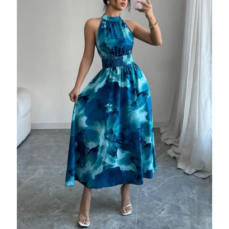 Chic women's sleeveless maxi dress, featuring a halter neck and comfortable smocked waist. Ideal for elegant casual wear.