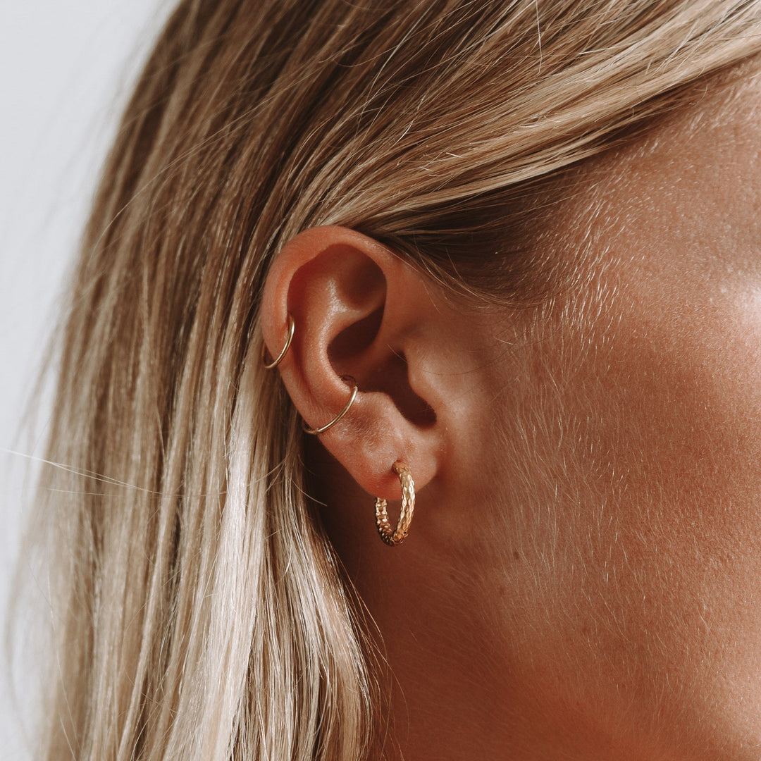 Hypoallergenic & waterproof hammered gold plated hoop earrings, ideal for daily elegance.