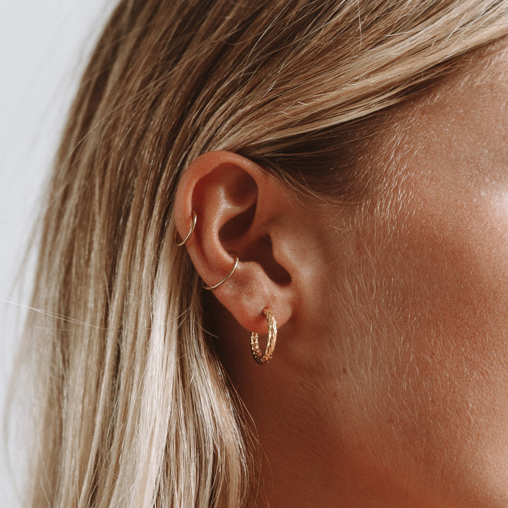 Hypoallergenic & waterproof hammered gold plated hoop earrings, ideal for daily elegance.