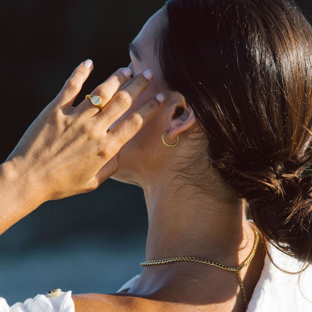 Pair of women's gold plated hammered hoop earrings, timeless, waterproof, and hypoallergenic.