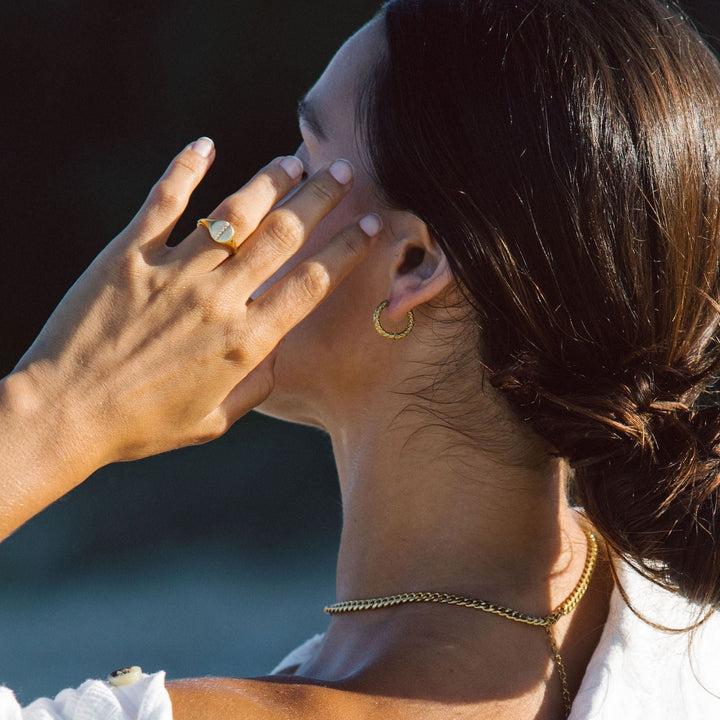 Pair of women's gold plated hammered hoop earrings, timeless, waterproof, and hypoallergenic.