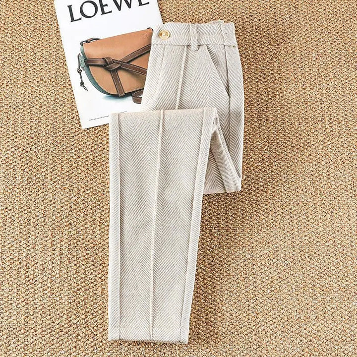 Tailored women's herringbone pencil-fit trousers, high-waisted, ideal for professional office wear.