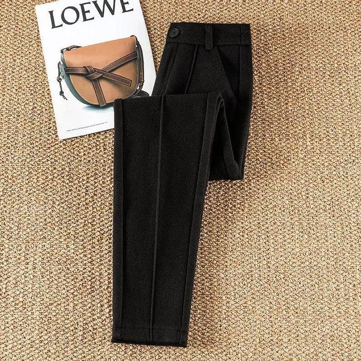 Sophisticated women's high-waisted herringbone trousers, a modern take on classic office wear.