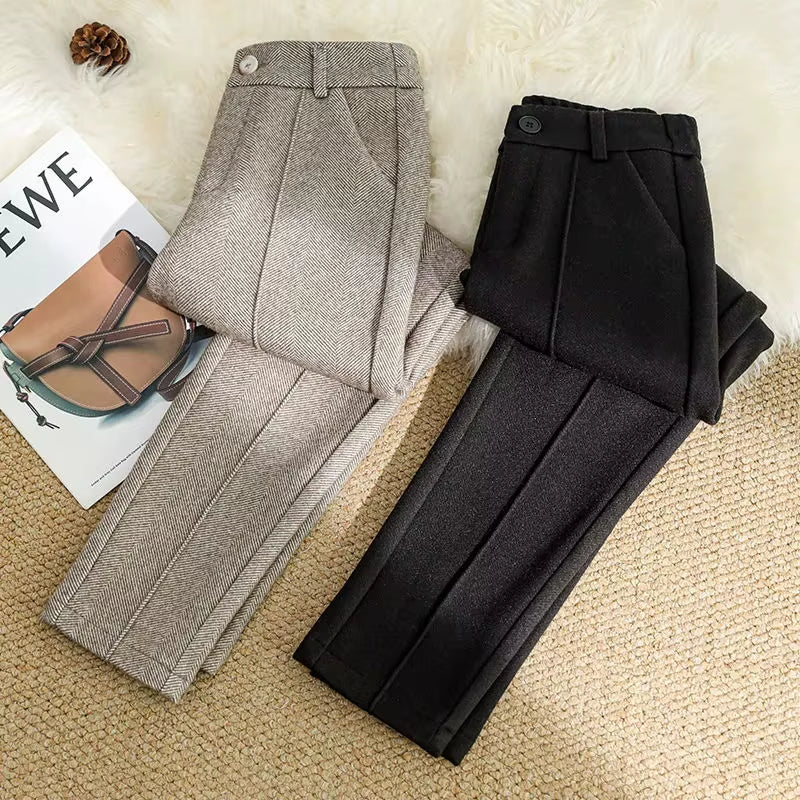 Detailed view of high-waisted women's herringbone trousers, showing the tailored waistband and clean finish.