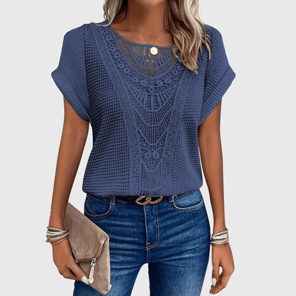 Fashionable women's Ibiza style lace blouse, worn by model, flattering fit for elegant summer fashion & resort wear.