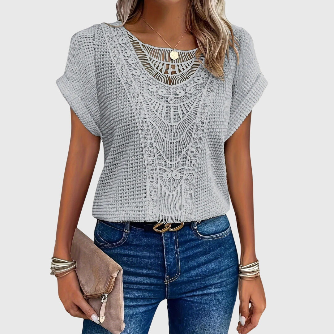 Women's elegant Ibiza style lace blouse styled casually, a fashionable top for summer fashion and versatile wear.