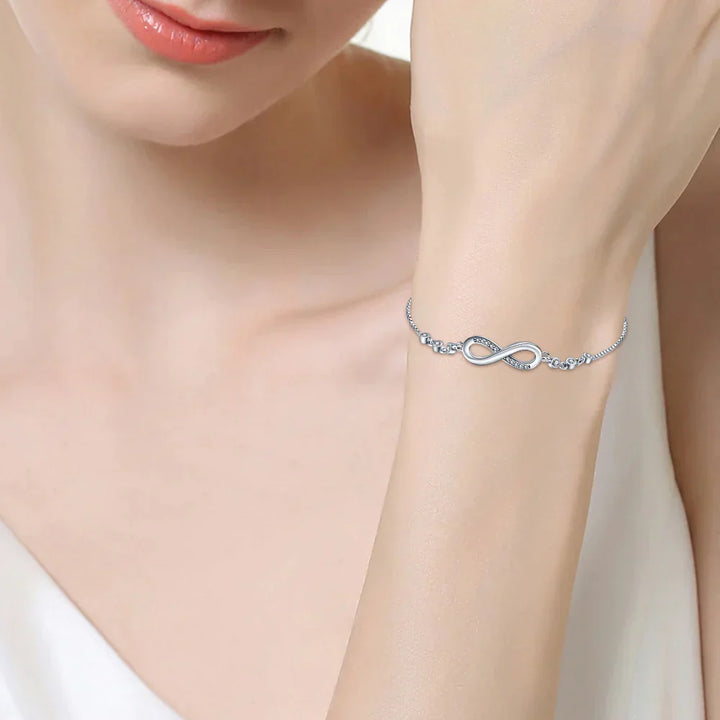Luxurious women's infinite link bracelet, an elegant stainless steel infinity jewelry piece. Adjustable and stylish.