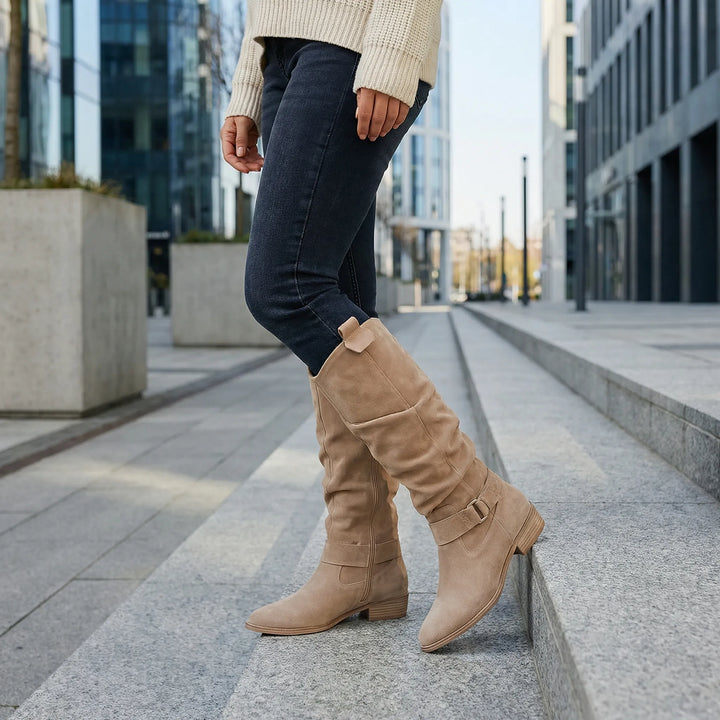 Women's elegant knee-high boots with a comfortable block heel and chic bow detail, perfect for fall fashion.