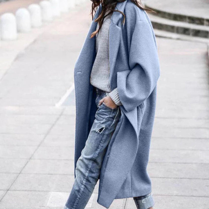 Women's elegant knee-length winter coat with a large collar, perfect for stylish cold weather fashion.