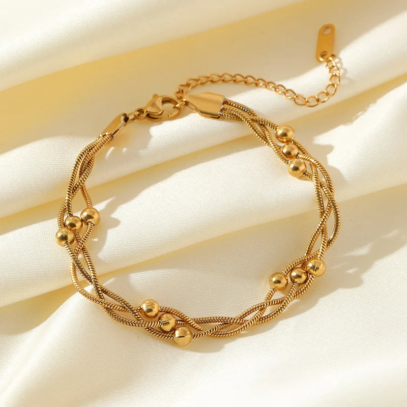 Elegant silver-tone layered snake chain bracelet for women, adjustable and chic. Durable stainless steel jewelry.