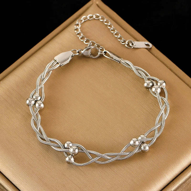 Stylish women's layered snake chain bracelet in silver, adjustable. Elegant stainless steel jewelry for women.